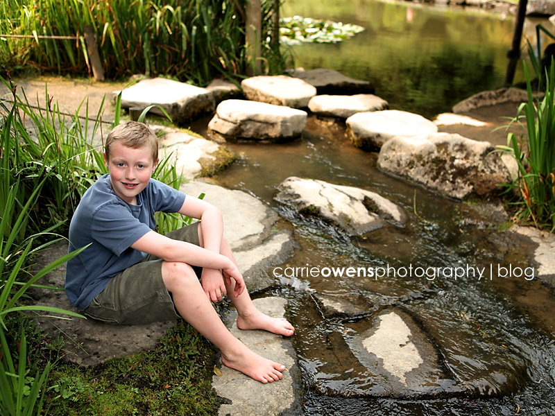 boy in the water at the japanese tea gardens in seattle