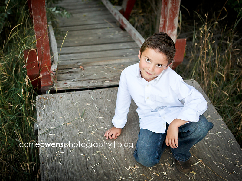 Salt Lake City child photographer boy crouching at bridge