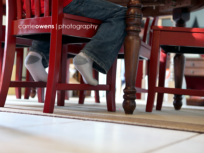 boy's feet at the breakfast table 