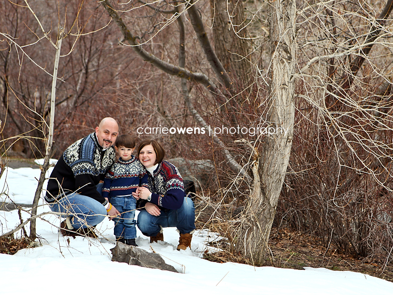 family of three in the snow in salt lake city by photographer Carrie Owens