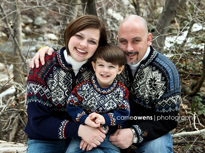 closeup of family of three in winter sweaters in the canyons of salt lake city utah