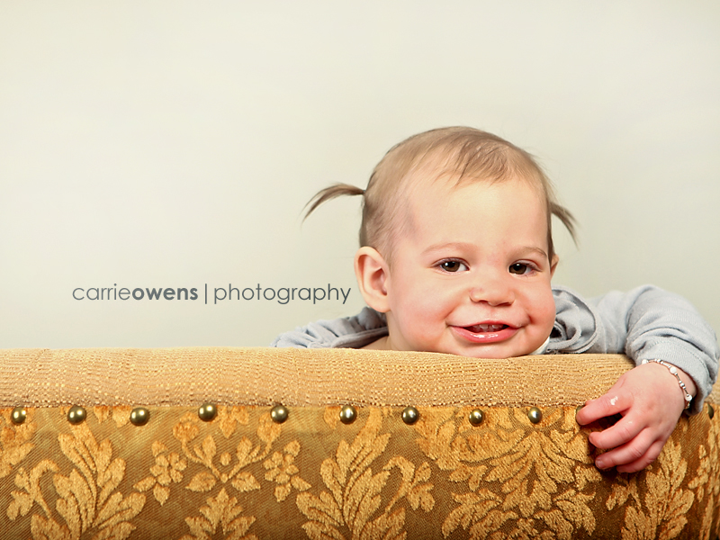 sandy utah photographer captures smiling one year old girl playing peek a boo