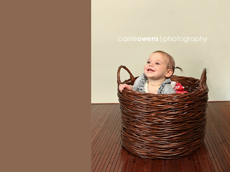 sandy utah photographer captures smiling one year old girl in a basket