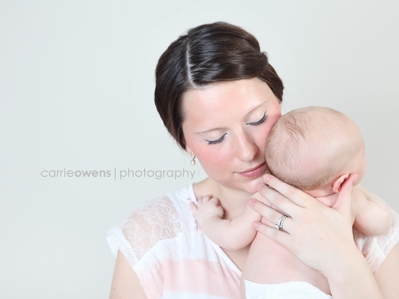 sandy utah newborn photographer baby on momma's shoulder while mom softly smiles