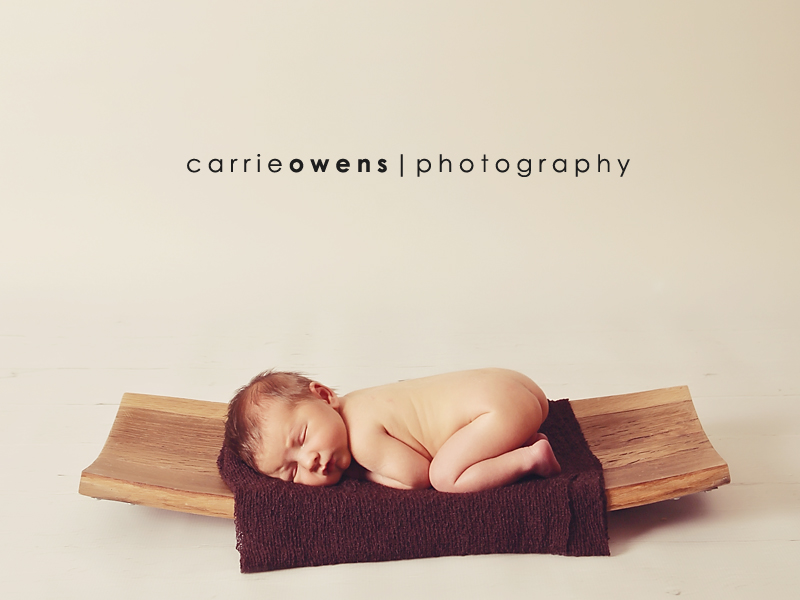 Newborn Photography in Salt Lake City Utah baby on wooden wine barrel tray by newborn photographer Carrie Owens