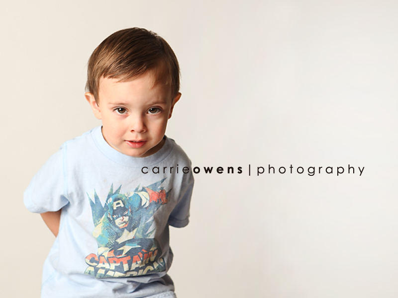 salt lake city utah child photographer Carrie Owens captures this cute young boy as he warms up to the camera in the studio