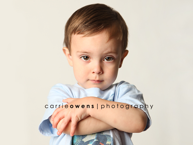 salt lake city utah child photographer Carrie Owens captures super cute young boy as he warms up to the camera in the studio