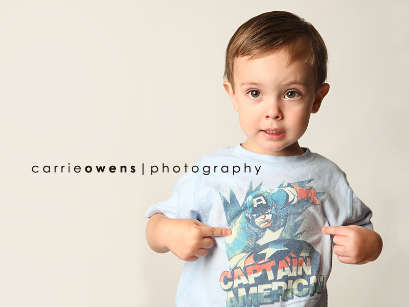 salt lake city utah child photographer Carrie Owens captures adorable young boy as he warms up to the camera in the studio
