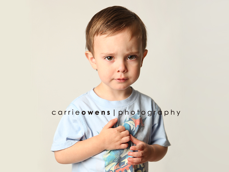 salt lake city utah child photographer Carrie Owens captures a bit of a serious young boy as he warms up to the camera in the studio