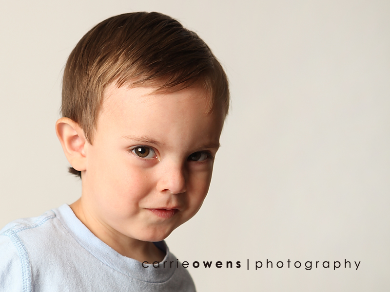 salt lake city utah child photographer Carrie Owens captures a sweet young boy as he warms up to the camera in the studio