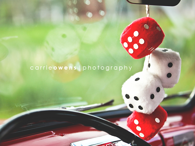 salt lake city utah engagment photographer Carrie Owens captures fuzzy dice in old red truck at a 50s themed engagement shoot