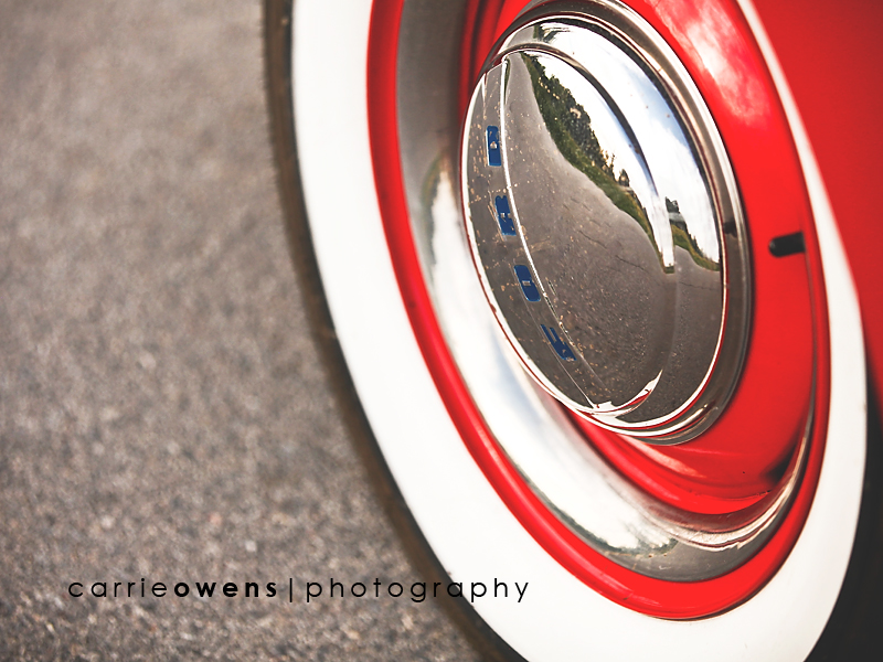 salt lake city utah engagment photographer Carrie Owens captures close up of tires of old red truck at a 50s themed engagement shoot
