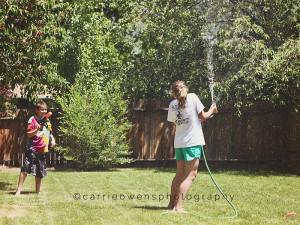 salt lake city utah family photographer summer time backyard fun playing with the hose