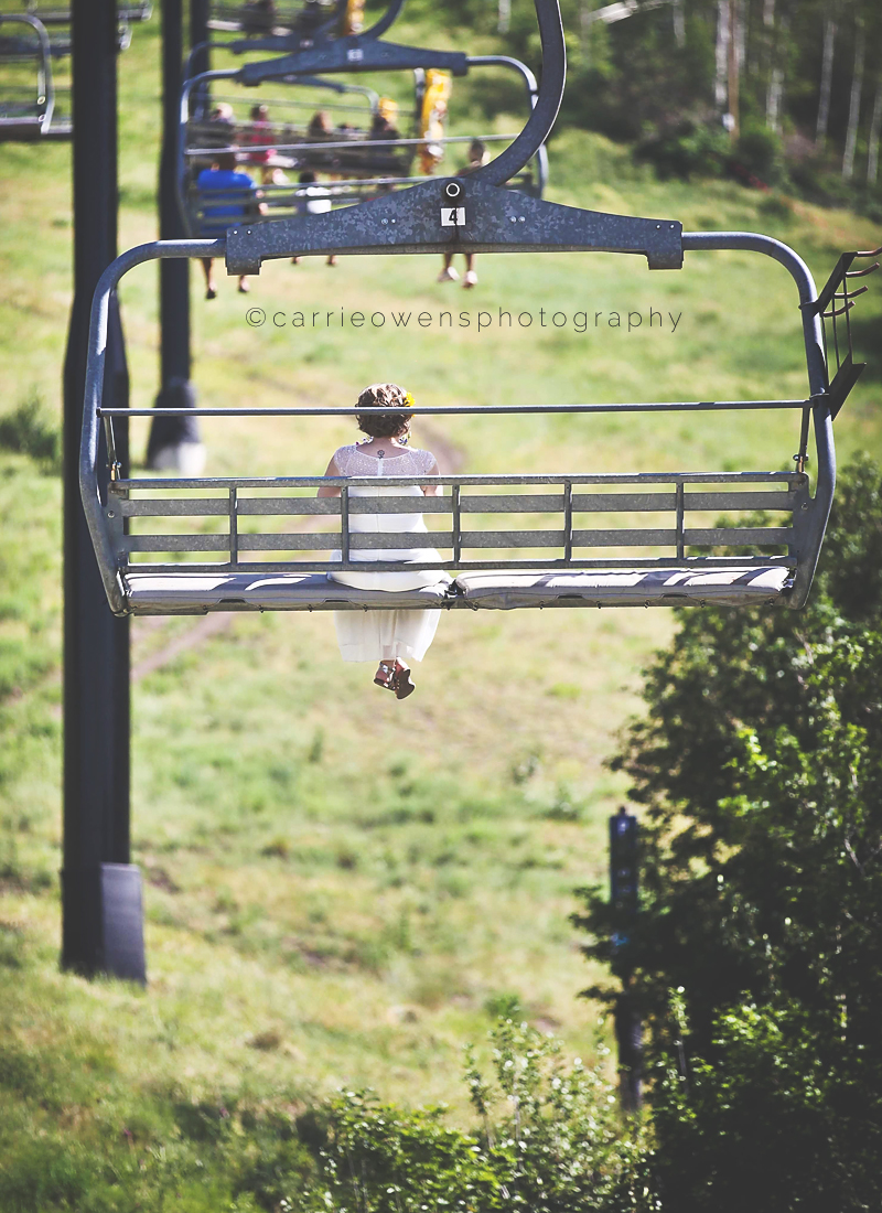 park city resort wedding photographed by carrie owens image of bride riding on the chair lift