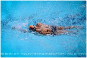 Salt Lake City Utah high school senior athlete photographer Carrie Owens photographs senior male swimmer at the pool
