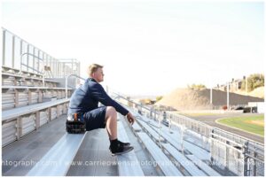 Cottonwood Heights high school senior photographer Carrie Owens photographs high school football player at the Brighton field