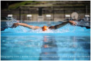 Salt Lake City Utah high school senior photographer Carrie Owens photographs senior swimmer at the pool