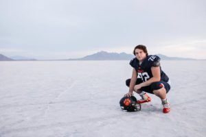 highschool football player senior photos at the salt flats in utah